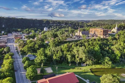 Scenic aerial shot of Lanesboro, MN featuring lush greenery and historic buildings.